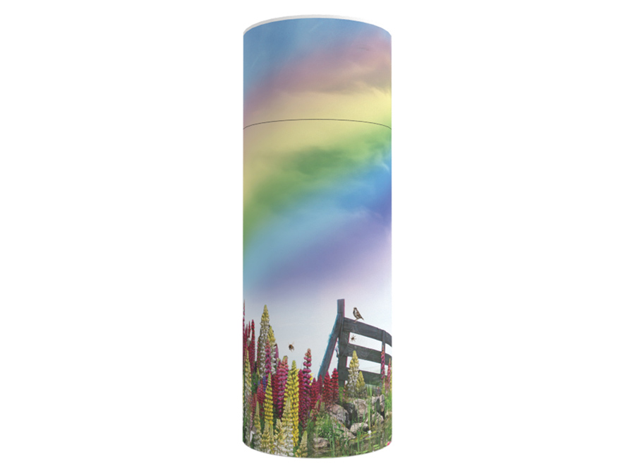 Cardboard scatter tube with an image of a rainbow and flowers in a field